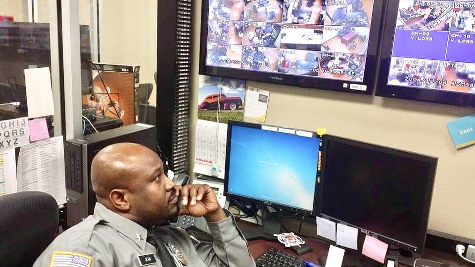 Security officer watching CCTV monitors in a control room