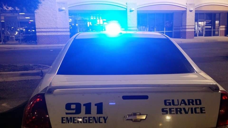 Guard service patrol car at night with its blue light on