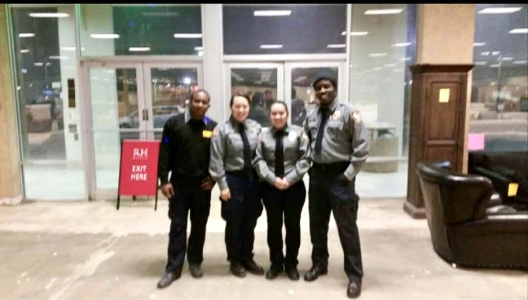 Four security officers standing in a building lobby